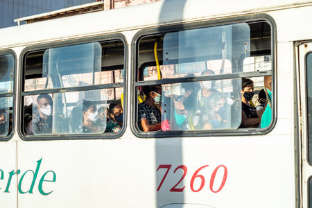 Salvador, Bahia, Brazil - November 01, 2021: People inside the bus wearing protective mask against covid-19 on the streets of Salvador, Bahia.のeditorial素材