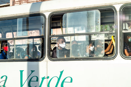 Salvador, Bahia, Brazil - November 01, 2021: People inside the bus wearing protective mask against covid-19 on the streets of Salvador, Bahia.のeditorial素材