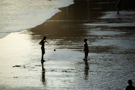 Salvador, Bahia, Brazil - November 01, 2021: Two young men playing beach soccer at Rio Vermelho beach in Salvador, Bahia in the late afternoon.のeditorial素材