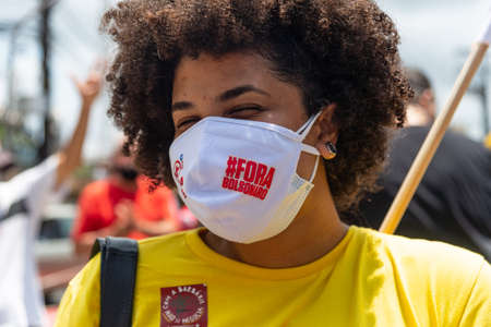 People wearing protective masks at the protest against President Jair Bolsonaro in downtown...