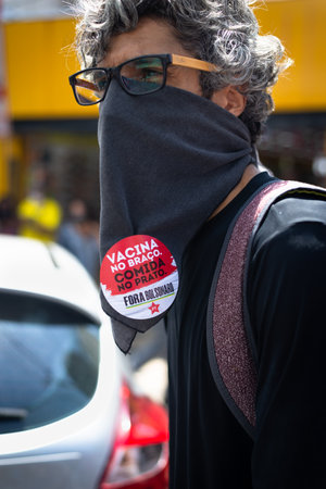 People wearing protective masks at the protest against President Jair Bolsonaro in downtown Salvador, Bahia.のeditorial素材