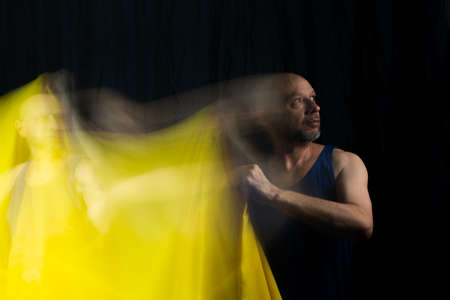 Time lapse view of woman moving a rag. Long exposure, motion blur. Salvador, Bahia, Brazil.の写真素材