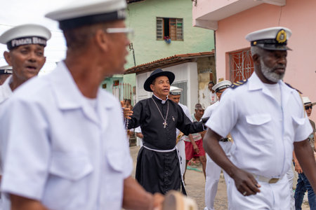 Saubara, Bahia, Brazil - August 03, 2019: Men, members of the cultural group CheganÃ§a dos Marujos, dance and sing in costumes during a performance at the streets of Saubara, Bahia.のeditorial素材
