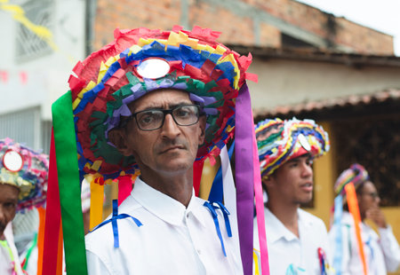 Saubara, Bahia, Brazil - August 03, 2019: Men, women and children, members of the cultural group CheganÃ§a dos Marujos, dance and sing in costumes during a performance at the streets of Saubara, Bahia.のeditorial素材