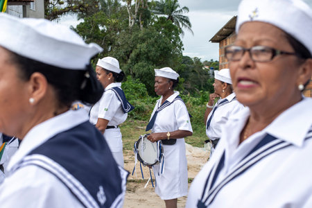 Saubara, Bahia, Brazil - August 03, 2019: Men, women and children, members of the cultural group CheganÃ§a dos Marujos, dance and sing in costumes during a performance at the streets of Saubara, Bahia.のeditorial素材