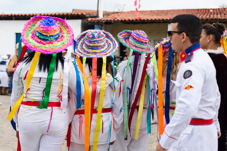Saubara, Bahia, Brazil - August 03, 2019: Men, women and children, members of the cultural group CheganÃ§a dos Marujos, dance and sing in costumes during a performance at the streets of Saubara, Bahia.のeditorial素材