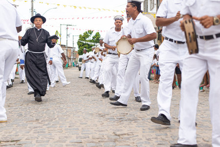Saubara, Bahia, Brazil - August 03, 2019: Men, members of the cultural group CheganÃ§a dos Marujos, dance and sing in costumes during a performance at the streets of Saubara, Bahia.のeditorial素材
