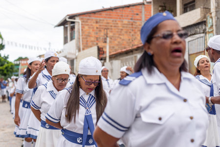 Saubara, Bahia, Brazil - August 03, 2019: Men, women and children, members of the cultural group CheganÃ§a dos Marujos, dance and sing in costumes during a performance at the streets of Saubara, Bahia.のeditorial素材
