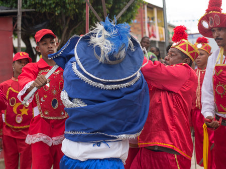 Saubara, Bahia, Brazil - August 03, 2019: Men, women and children, members of the cultural group CheganÃ§a dos Marujos, dance and sing in costumes during a performance at the streets of Saubara, Bahia.のeditorial素材