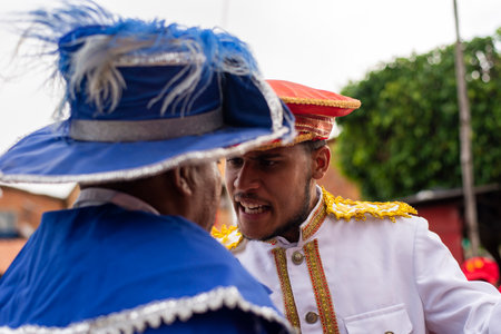 Saubara, Bahia, Brazil - August 03, 2019: Men, women and children, members of the cultural group CheganÃ§a dos Marujos, dance and sing in costumes during a performance at the streets of Saubara, Bahia.のeditorial素材