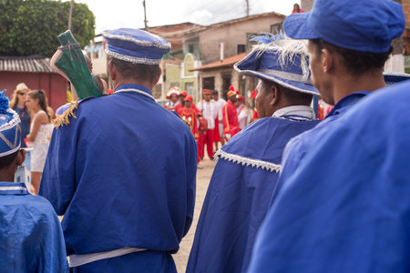 Saubara, Bahia, Brazil - August 03, 2019: Men, women and children, members of the cultural group CheganÃ§a dos Marujos, dance and sing in costumes during a performance at the streets of Saubara, Bahia.のeditorial素材