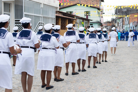 Saubara, Bahia, Brazil - August 03, 2019: Men, women and children, members of the cultural group CheganÃ§a dos Marujos, dance and sing in costumes during a performance at the streets of Saubara, Bahia.のeditorial素材