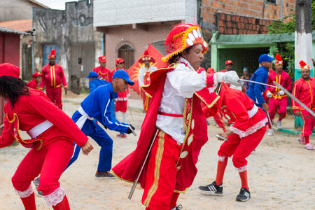 Saubara, Bahia, Brazil - August 03, 2019: Men, women and children, members of the cultural group CheganÃ§a dos Marujos, dance and sing in costumes during a performance at the streets of Saubara, Bahia.のeditorial素材