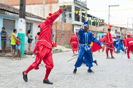 Saubara, Bahia, Brazil - August 03, 2019: Men, women and children, members of the cultural group CheganÃ§a dos Marujos, dance and sing in costumes during a performance at the streets of Saubara, Bahia.のeditorial素材
