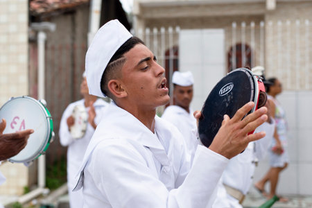 Saubara, Bahia, Brazil - August 03, 2019: Men, women and children, members of the cultural group CheganÃ§a dos Marujos, dance and sing in costumes during a performance at the streets of Saubara, Bahia.のeditorial素材