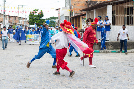 Saubara, Bahia, Brazil - August 03, 2019: Men, women and children, members of the cultural group CheganÃ§a dos Marujos, dance and sing in costumes during a performance at the streets of Saubara, Bahia.のeditorial素材
