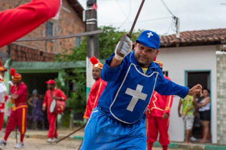 Saubara, Bahia, Brazil - August 03, 2019: Men, women and children, members of the cultural group CheganÃ§a dos Marujos, dance and sing in costumes during a performance at the streets of Saubara, Bahia.のeditorial素材