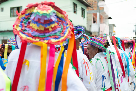Saubara, Bahia, Brazil - August 03, 2019: Men, women and children, members of the cultural group CheganÃ§a dos Marujos, dance and sing in costumes during a performance at the streets of Saubara, Bahia.のeditorial素材