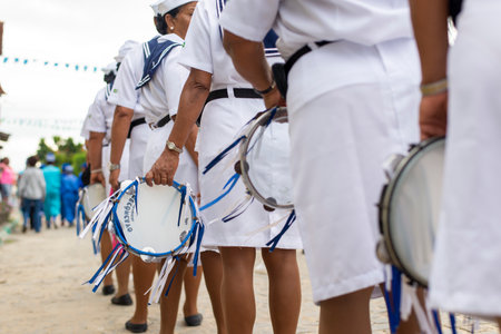 Saubara, Bahia, Brazil - August 03, 2019: Men, women and children, members of the cultural group CheganÃ§a dos Marujos, dance and sing in costumes during a performance at the streets of Saubara, Bahia.のeditorial素材