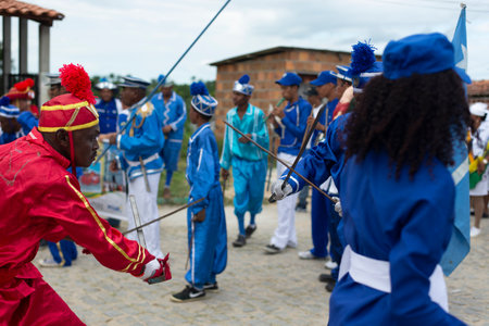 Saubara, Bahia, Brazil - August 03, 2019: Men, women and children, members of the cultural group CheganÃ§a dos Marujos, dance and sing in costumes during a performance at the streets of Saubara, Bahia.のeditorial素材