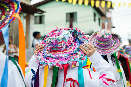 Saubara, Bahia, Brazil - August 03, 2019: Men, women and children, members of the cultural group CheganÃ§a dos Marujos, dance and sing in costumes during a performance at the streets of Saubara, Bahia.のeditorial素材