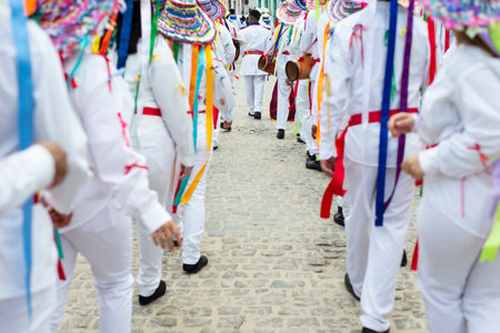 Saubara, Bahia, Brazil - August 03, 2019: Men, women and children, members of the cultural group CheganÃ§a dos Marujos, dance and sing in costumes during a performance at the streets of Saubara, Bahia.のeditorial素材