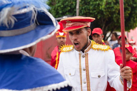 Saubara, Bahia, Brazil - August 03, 2019: Men, women and children, members of the cultural group CheganÃ§a dos Marujos, dance and sing in costumes during a performance at the streets of Saubara, Bahia.のeditorial素材