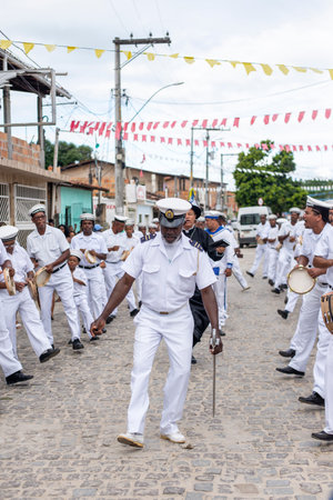 Saubara, Bahia, Brazil - August 03, 2019: Men, members of the cultural group CheganÃ§a dos Marujos, dance and sing in costumes during a performance at the streets of Saubara, Bahia.のeditorial素材