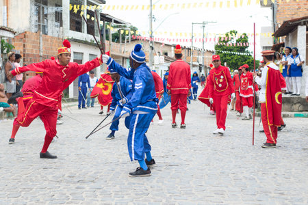 Saubara, Bahia, Brazil - August 03, 2019: Men, women and children, members of the cultural group CheganÃ§a dos Marujos, dance and sing in costumes during a performance at the streets of Saubara, Bahia.のeditorial素材