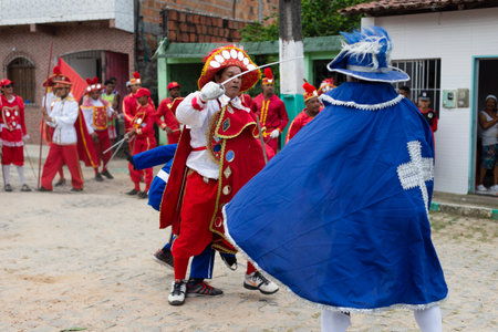 Saubara, Bahia, Brazil - August 03, 2019: Men, women and children, members of the cultural group CheganÃ§a dos Marujos, dance and sing in costumes during a performance at the streets of Saubara, Bahia.のeditorial素材
