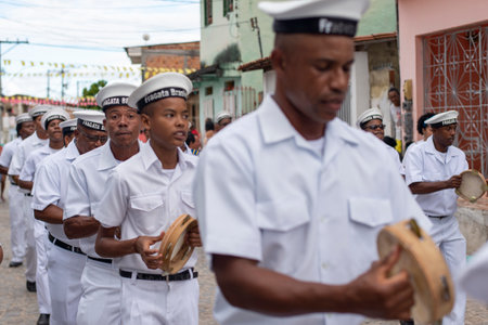 Saubara, Bahia, Brazil - August 03, 2019: Men, members of the cultural group CheganÃ§a dos Marujos, dance and sing in costumes during a performance at the streets of Saubara, Bahia.のeditorial素材