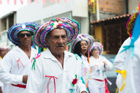 Saubara, Bahia, Brazil - August 03, 2019: Men, women and children, members of the cultural group CheganÃ§a dos Marujos, dance and sing in costumes during a performance at the streets of Saubara, Bahia.のeditorial素材