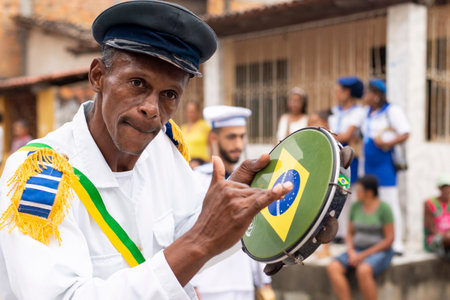 Saubara, Bahia, Brazil - August 03, 2019: Men, women and children, members of the cultural group CheganÃ§a dos Marujos, dance and sing in costumes during a performance at the streets of Saubara, Bahia.のeditorial素材