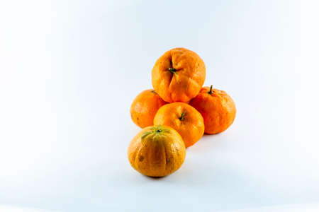 Surface covered with five ripe fresh juicy tangerines, composition isolated over the white background.の写真素材