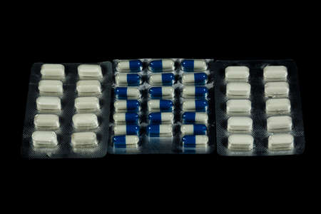 Pill pack for various diseases on a black background.