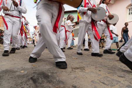 Saubara, Bahia, Brazil - August 06, 2022: Low view of the legs of Marujada de Curaca members dancing at the Chegancas cultural meeting in Saubara, Bahia.のeditorial素材