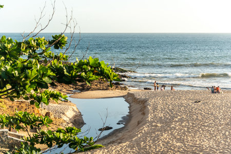 Salvador, Bahia, Brazil - December 11, 2021: View of people on the beach against the sea and blue sky. Praia da Barra in Salvador, Bahia.のeditorial素材