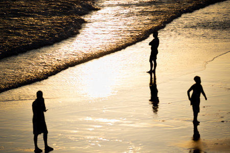 Salvador, Bahia, Brazil - November 01, 2021: People walking and having fun on the sand of Rio Vermelho beach in Salvador, Bahia, in the late afternoon.のeditorial素材