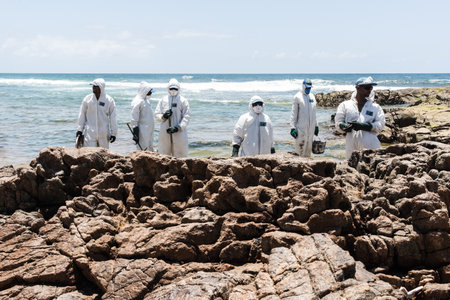 Salvador, Bahia, Brazil - October 26, 2019: Cleaning agents extract oil from Pedra do Sal beach in the city of Salvador. The site was affected by an oil spill off the coast of Bahia.のeditorial素材