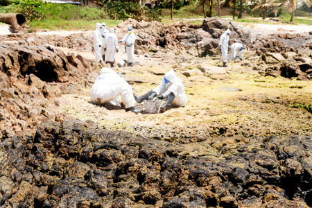 Salvador, Bahia, Brazil - October 26, 2019: Cleaning agents extract oil from Pedra do Sal beach in the city of Salvador. The site was affected by an oil spill off the coast of Bahia.のeditorial素材