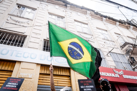 Salvador, Bahia, Brazil - November 20, 2021: Brazilians protest waving flags against the government of President Jair Bolsonaro in the city of Salvador, Bahia.のeditorial素材