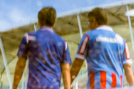 Salvador, Bahia, Brazil - April 01, 2018: Supporters of the Esporte Clube Bahia football team, seen through the reflection of the water in the vicinity of the Arena Fonte Nova stadium. Salvador, Bahia.のeditorial素材