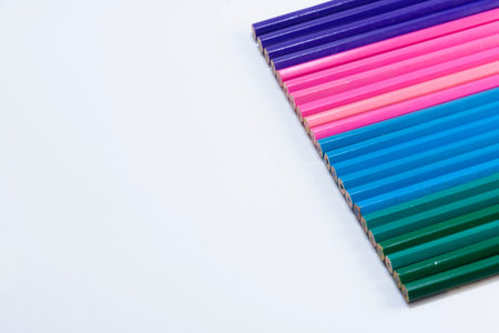 Lilac, pink, blue and green wooden pencils isolated on white background. close upの写真素材