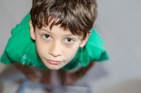 Top view portrait of a cheerful, playful child looking at the camera. Happiness concept. Salvador, Bahia, Brazil.の写真素材
