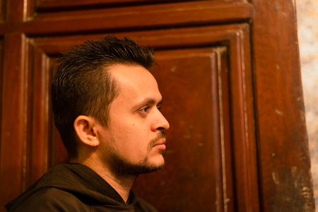 Salvador, Bahia, Brazil - June 16, 2022; Catholic friar praying against a wooden door inside the basilica Cathedral at Largo do Pelourinho in Salvador, Brazil.のeditorial素材