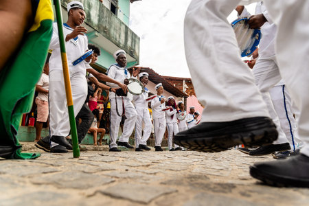 Saubara, Bahia, Brazil - August 06, 2022: Low view of members of the cultural manifestation Encontro de Chegancas in Saubara, Bahia, who parade and dance through the streets.のeditorial素材