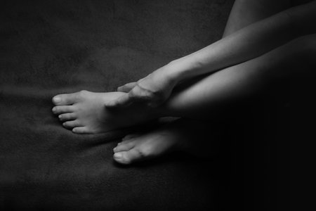 Female Nude silhouette. Black and white portrait. Part of the woman's legs. Sexy mature woman. Young adult with Naked Body.の写真素材