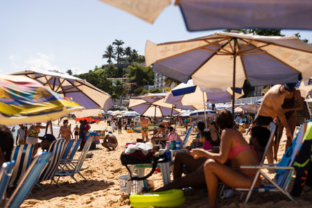 Salvador, Bahia, Brazil - June 04, 2022: People have fun and swim in the sea at Porto da Barra beach in the city of Salvador, Bahia.のeditorial素材