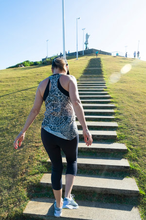A woman walking up the stairs of Morro do Cristo in the Barra neighborhood in the city of Salvador, Bahia.のeditorial素材