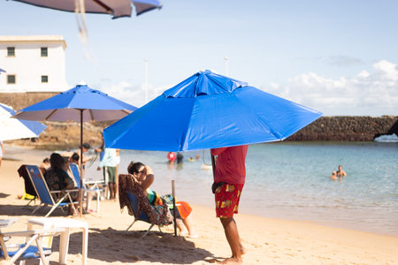 People have fun and swim in the sea at Porto da Barra beach in the city of Salvador, Bahia.のeditorial素材